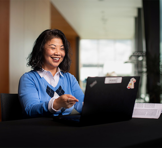 two individuals stand side by side with shovels, one wrapped in blue and the other in purple
