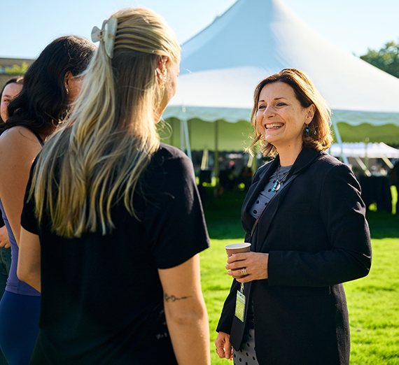 President Katia Passerini stands in front of windows in Hemmingson Center