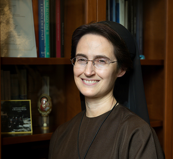 President Katia Passerini stands in front of windows in Hemmingson Center